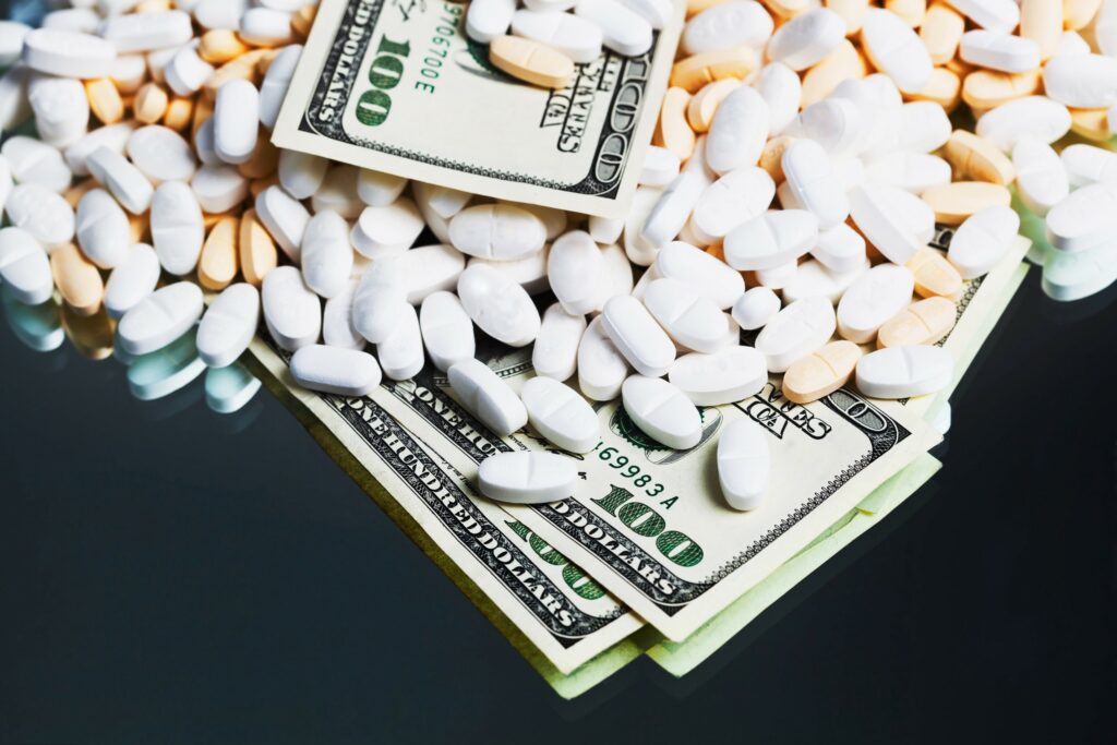 Prescription medications on a table with money
