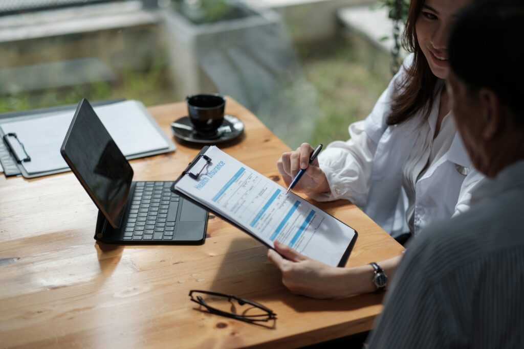 A health navigator and patient review Essential Health Benefits in an office.